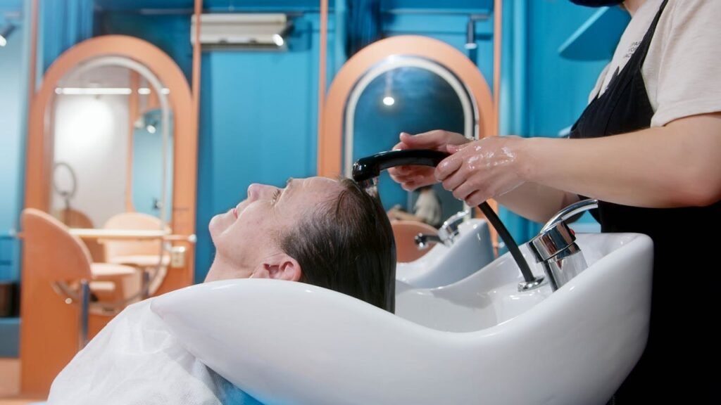 The Art of Drawing Readers In: Your attractive post title goes here A senior woman gets a relaxing hair wash at a vibrant, modern salon setting.