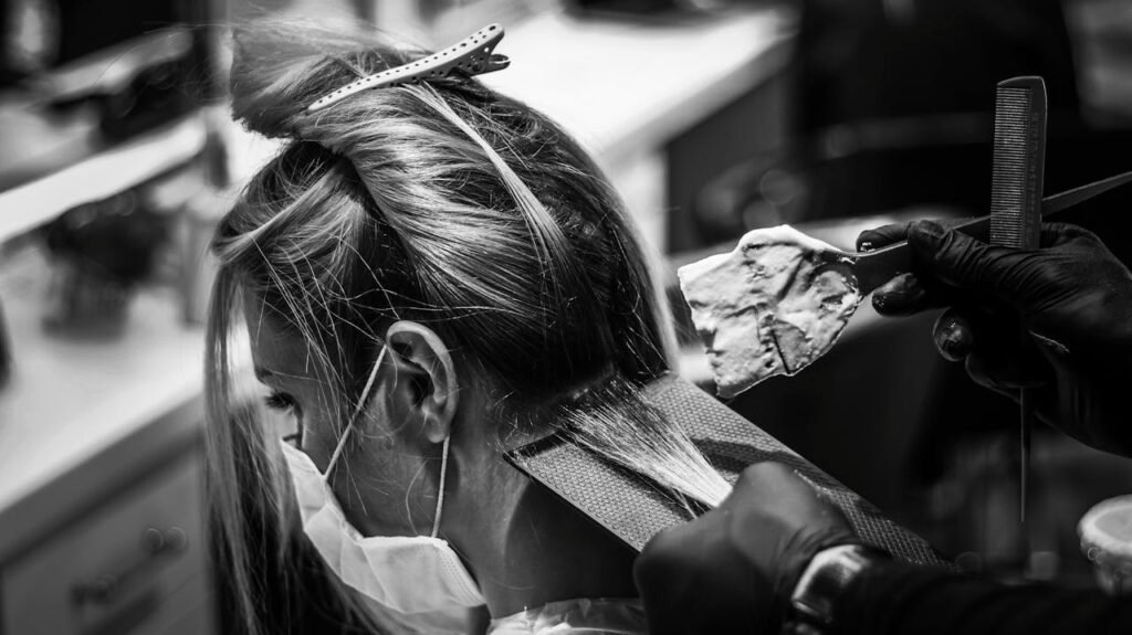 Mastering the First Impression: Your intriguing post title goes here Monochrome image of a woman getting her hair colored in a salon.